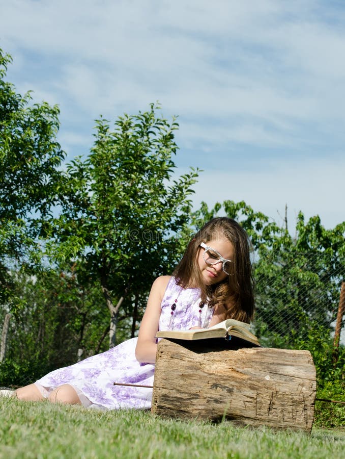 Young woman reading the Bible in the garden. Young woman reading the Bible in the garden