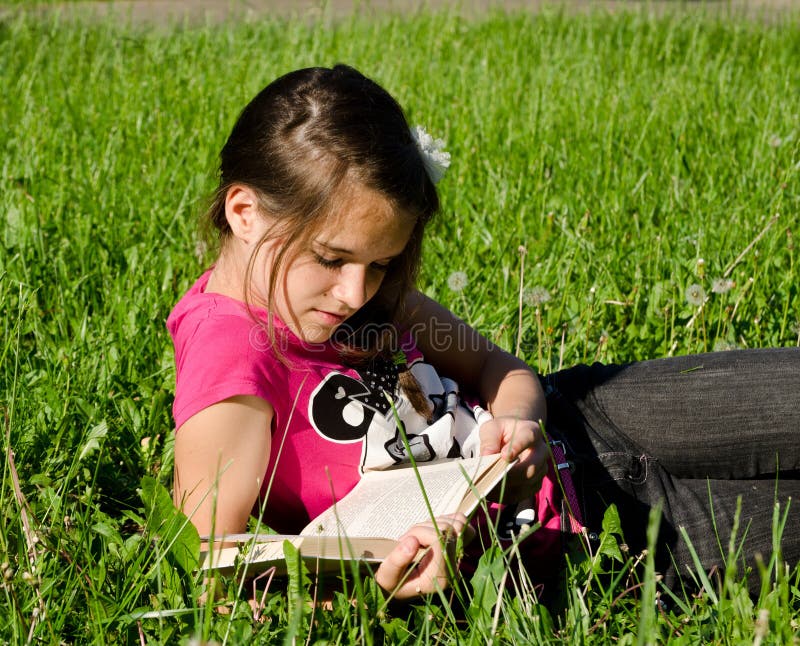 Teenager girl enjoy reading a book in summer field. Teenager girl enjoy reading a book in summer field