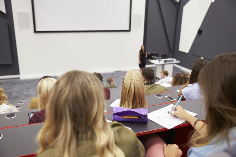 Lecture at university lecture theatre, audience POV, closer royalty free stock image
