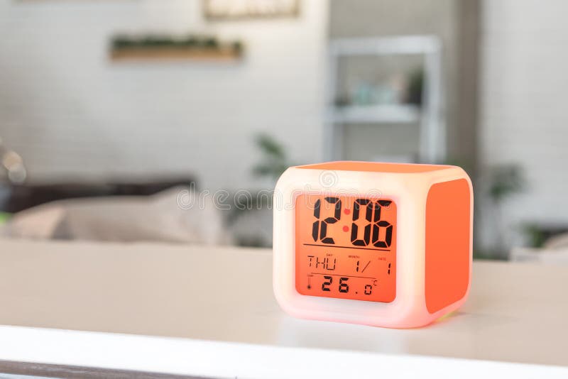 LED alarm clock standing on table background. Digital timer display. Copyspace for your design stock photo LED alarm clock standing on table background. Digital timer display. Copyspace for your design stock photo