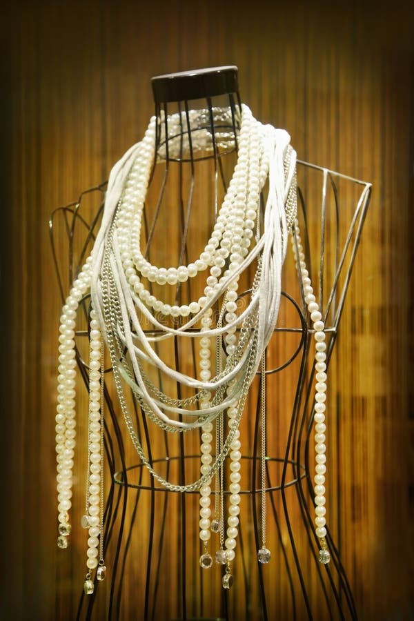 Mannequin with necklaces in store showcase. Mannequin with necklaces in store showcase
