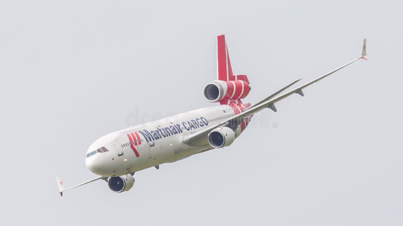 LEEUWARDEN, THE NETHERLANDS - JUNE 11, 2016: PH-MCU Martinair Holland McDonnell Douglas MD-11 during a demonstration at the Royal Netherlands Air Force Days. LEEUWARDEN, THE NETHERLANDS - JUNE 11, 2016: PH-MCU Martinair Holland McDonnell Douglas MD-11 during a demonstration at the Royal Netherlands Air Force Days