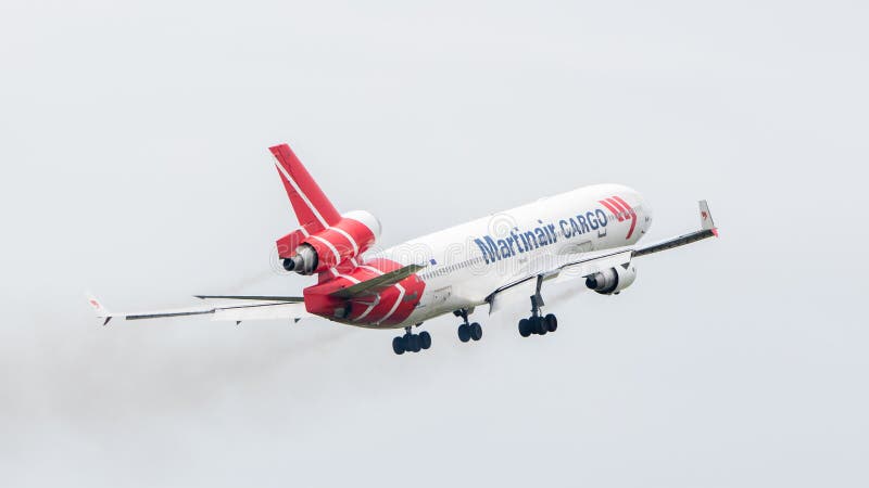 LEEUWARDEN, THE NETHERLANDS - JUNE 11, 2016: PH-MCU Martinair Holland McDonnell Douglas MD-11 during a demonstration at the Royal Netherlands Air Force Days. LEEUWARDEN, THE NETHERLANDS - JUNE 11, 2016: PH-MCU Martinair Holland McDonnell Douglas MD-11 during a demonstration at the Royal Netherlands Air Force Days