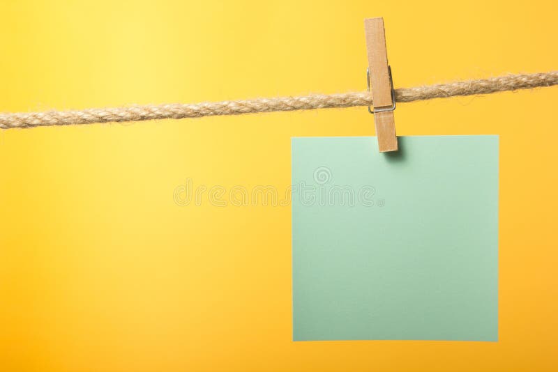 Blank paper notes hanging on rope with clothes pins, copy space for text or image or product placement. Reminder. Blank paper notes hanging on rope with clothes pins, copy space for text or image or product placement. Reminder