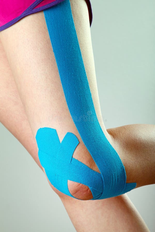 Leg with blue physio tape stock image. Image of body 36119125