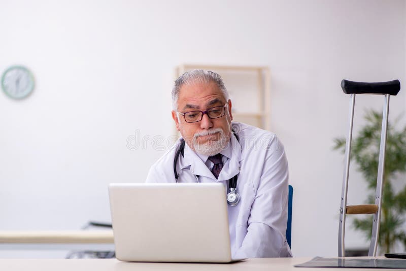 Leg Injured Old Male Doctor Working in the Clinic Stock Image - Image ...