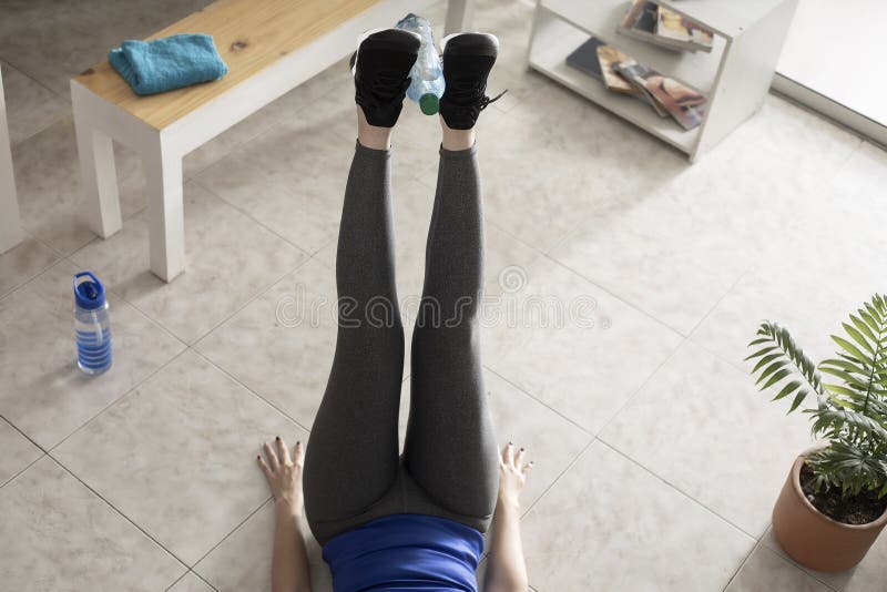 https://thumbs.dreamstime.com/b/leg-lift-water-bottle-stay-home-concept-woman-exercising-doing-crunches-floor-homemade-items-182517160.jpg