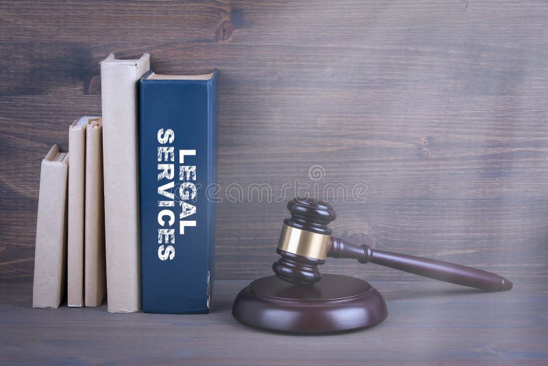 Legal Services. Wooden gavel and books in background. Law and justice concept