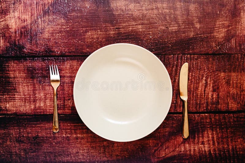 Empty plate with cutlery, top view, concept of intermittent fasting diet to lose weight. Empty plate with cutlery, top view, concept of intermittent fasting diet to lose weight.