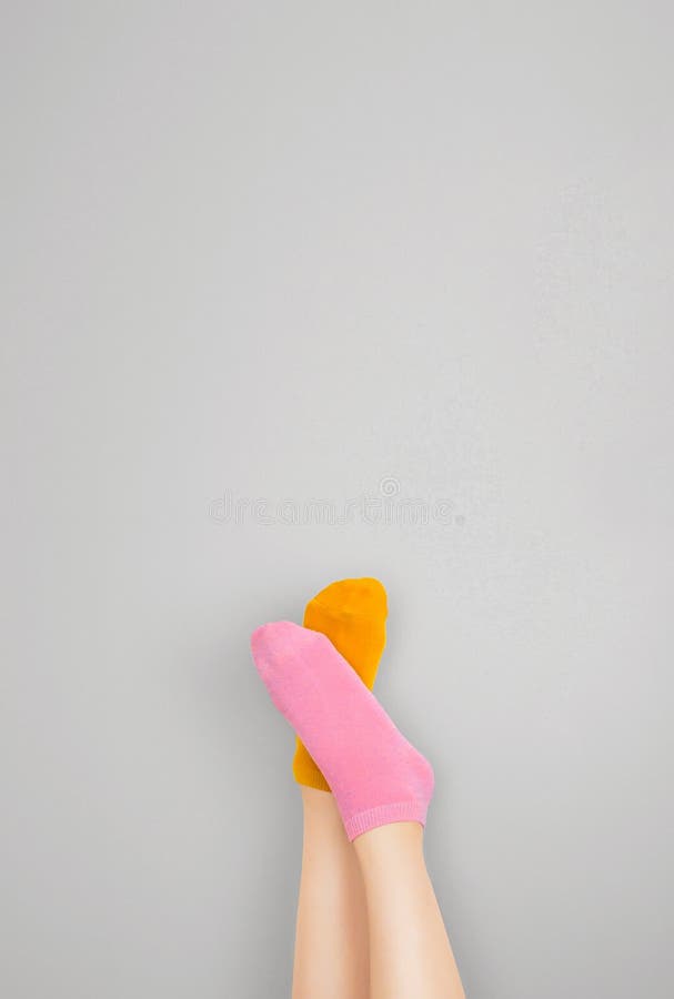 Legs and Feet with Cute Sock. Woman Wearing Pastel Pink and Yellow Socks  Raised Crossed Leg on Gray Background Stock Photo - Image of beautiful,  clothes: 157306034