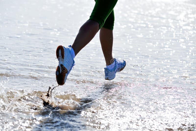 Legs of a girl jogging on the beach