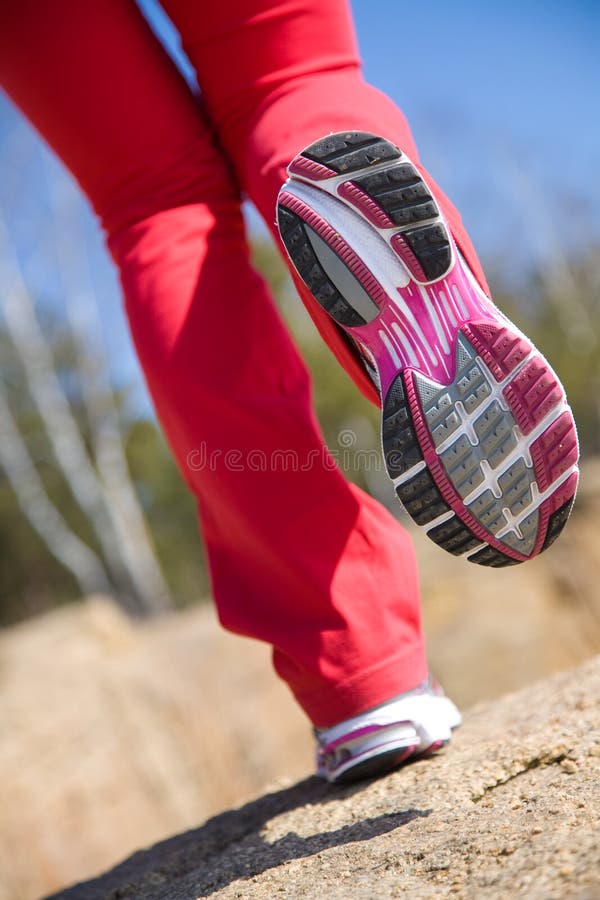 Close-up legs of a girl jogging on the wood. Close-up legs of a girl jogging on the wood