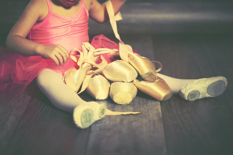 Legs a little ballerina with ballet pointe shoes and pink skirt