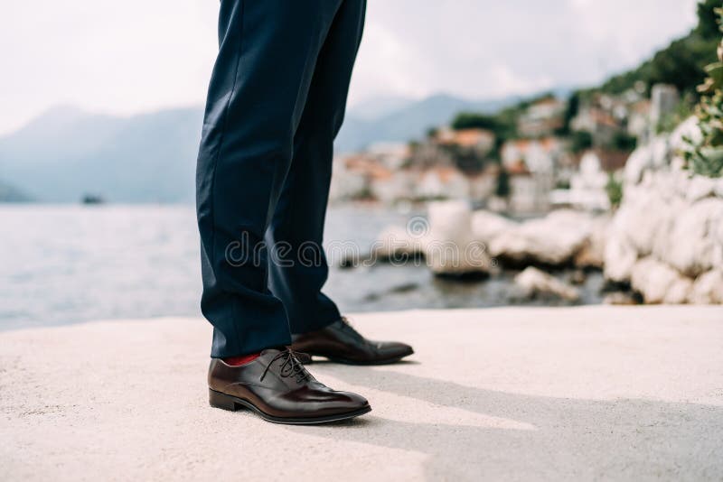 Legs of a Man in Blue Pants, Red Socks and Brown Shoes Standing on the  Pier, Close-up Stock Photo - Image of pants, elegant: 221210708
