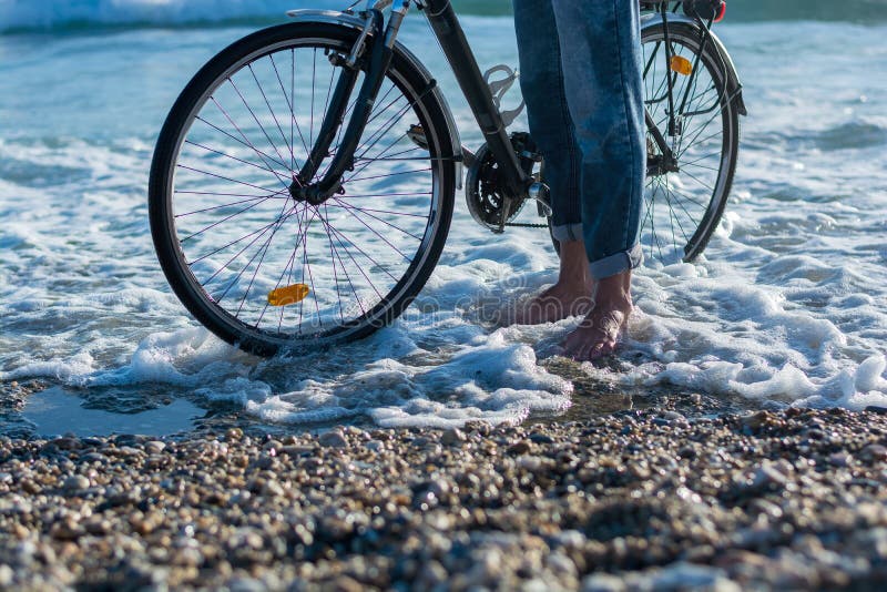 The Legs of a Man Who Walking with a Bicycle Along the Seashore. Stock ...