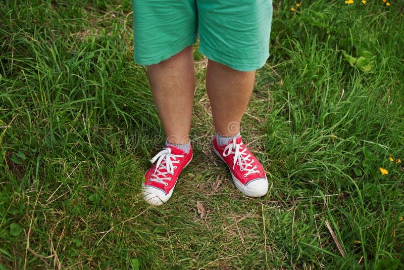 Legs men dressed in red sneakers.