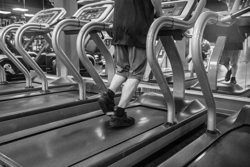 Legs running person on a treadmill royalty free stock photography