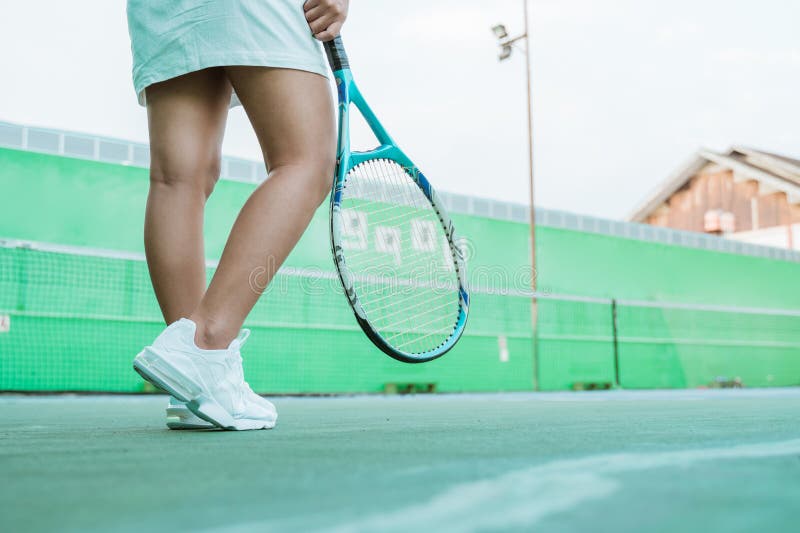 Legs of Tennis Player Wearing Skirt and Holding Racket Stock Photo ...