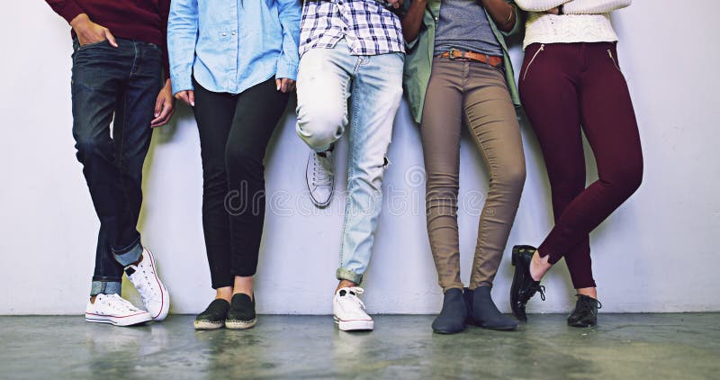 Group of Students Standing at Wall, Legs and Friends and Youth Relax in ...