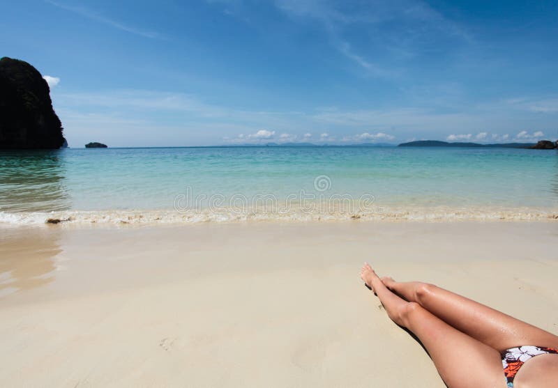 Legs of young woman on the beach