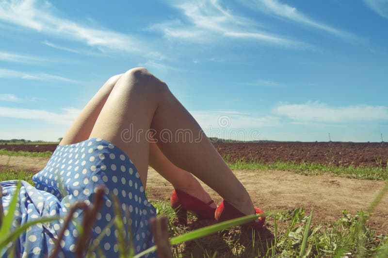 Legs of a young woman near a dirt road royalty free stock photo Legs of a young woman near a dirt road royalty free stock photo