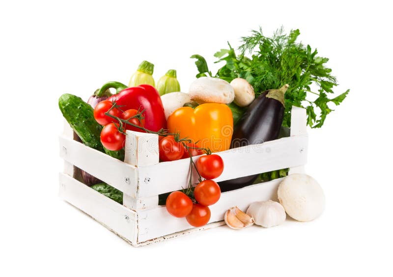 Fresh vegetables in a painted wooden box isolated on white background. Fresh vegetables in a painted wooden box isolated on white background