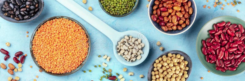 Legumes, overhead panoramic shot on a blue background. Vibrant pulses including colorful beans, lentils, chickpeas, a flat lay composition. Legumes, overhead panoramic shot on a blue background. Vibrant pulses including colorful beans, lentils, chickpeas, a flat lay composition