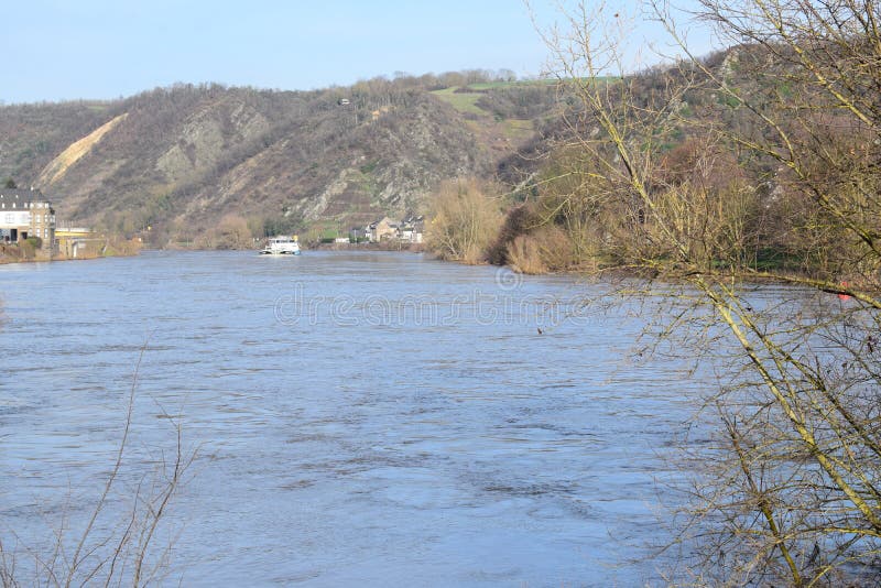 Mosel valley road near Lehmen during the winter flood with muddy water covering the lower parts along the river. Moselle is still low in 2023, the floods before were higher. Mosel valley road near Lehmen during the winter flood with muddy water covering the lower parts along the river. Moselle is still low in 2023, the floods before were higher