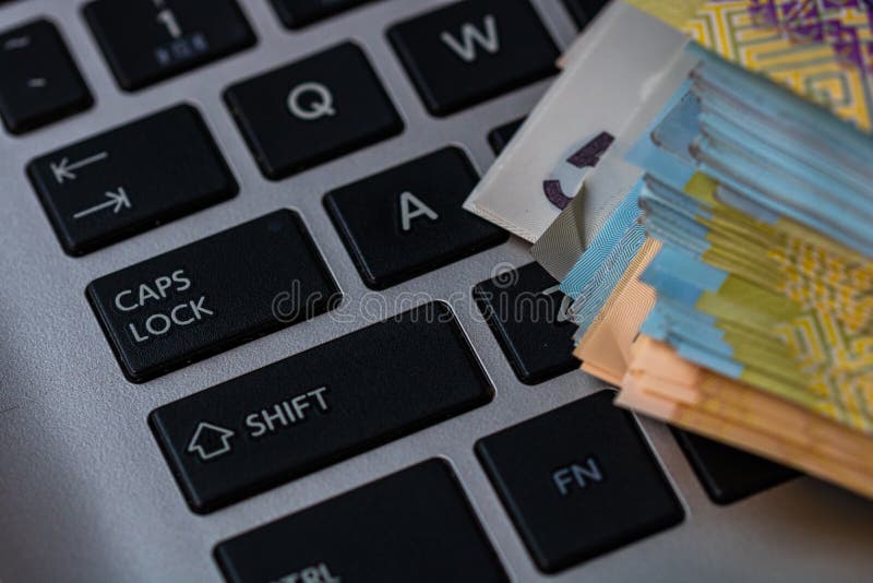 Lei banknotes on keyboard. Selective focus on stack of LEI romanian money