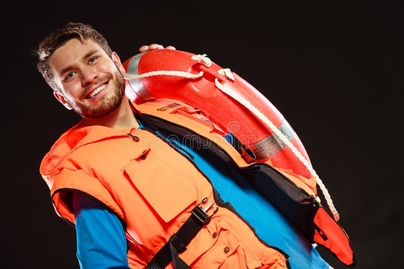 Leibwächter in der Schwimmweste mit Rettungsringrettungsring stockfotografie Leibwächter in der Schwimmweste mit Rettungsringrettungsring stockfotografie