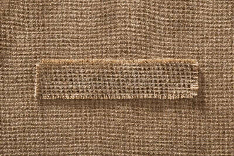 Burlap Fabric Frame Piece Label over Sack Cloth Linen Hessian Brown Background. Burlap Fabric Frame Piece Label over Sack Cloth Linen Hessian Brown Background