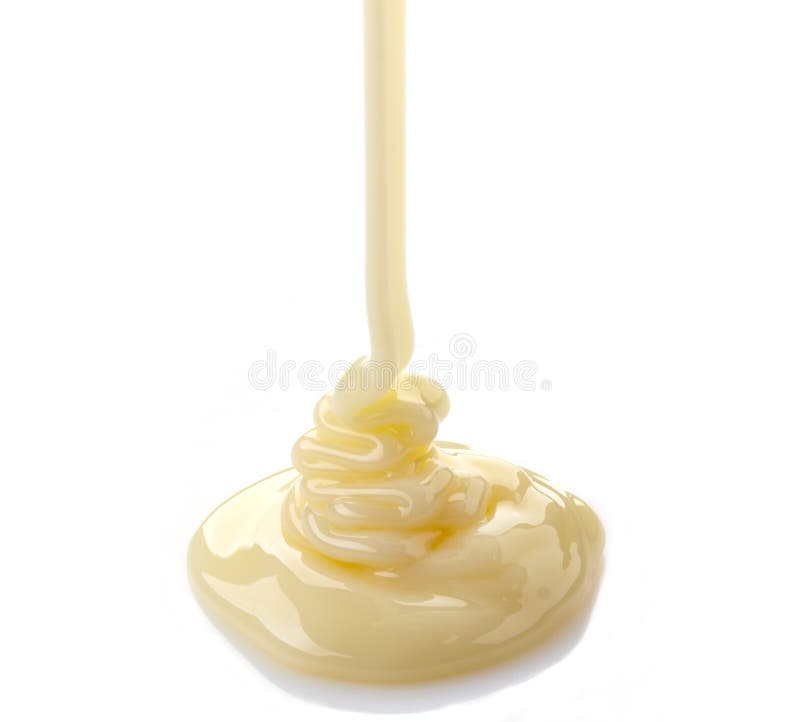 Pouring condensed milk on a white background. Pouring condensed milk on a white background