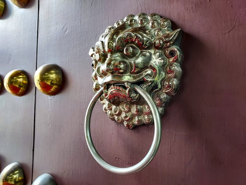 Lejondörrsknapp på porten till den kinesiska stilbyggnaden