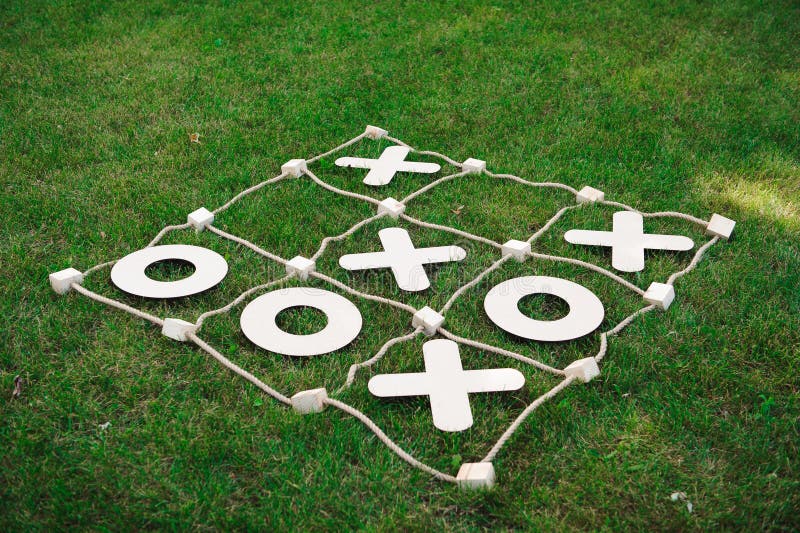 Lek för muskelryckningTac-Toe Lek på grönt gräs royaltyfri bild Lek för muskelryckningTac-Toe Lek på grönt gräs royaltyfri bild