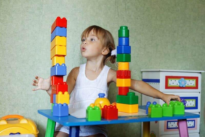 Cute child playing with the constructor bricks at home. Cute child playing with the constructor bricks at home