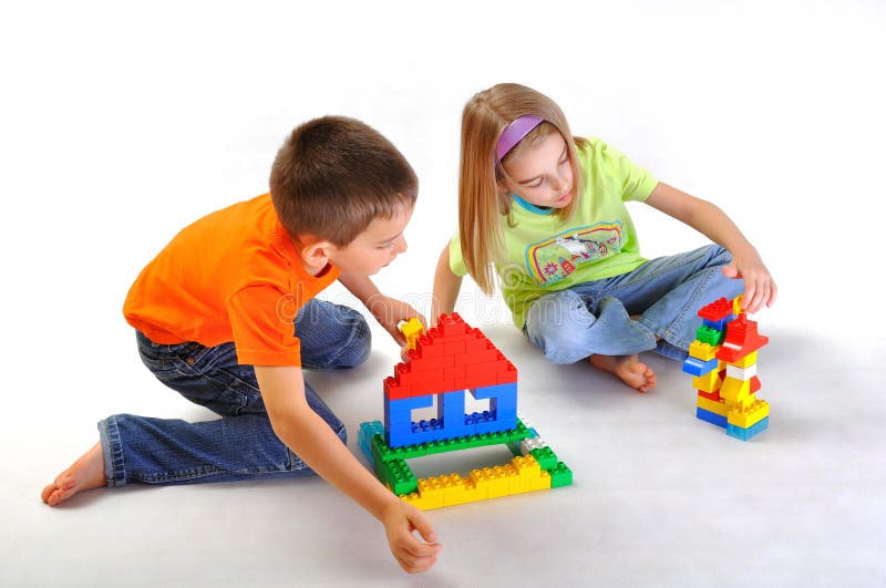 Kids boy and girl playing and building house with constructor isolated on white background. Kids boy and girl playing and building house with constructor isolated on white background