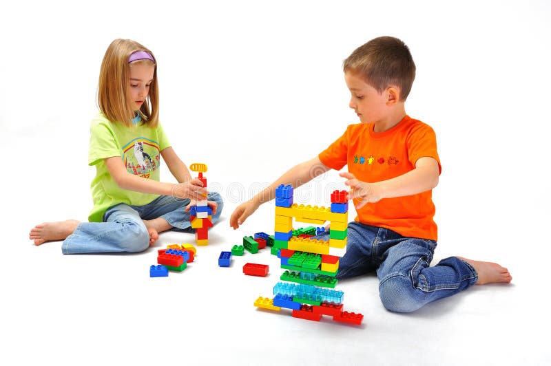 Boy and girl two children playing building with constructor, isolated on white. Boy and girl two children playing building with constructor, isolated on white