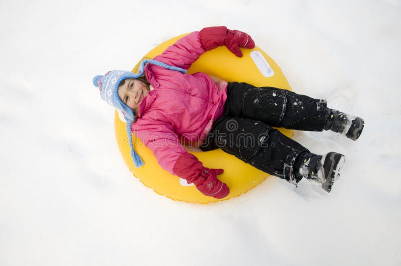 Cute girl sliding on snow. Cute girl sliding on snow