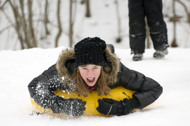 Teenage girl sliding on snow. Teenage girl sliding on snow