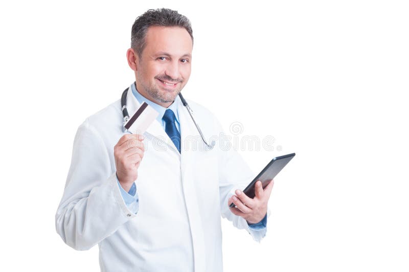 Doctor or medic holding credit card and wireless tablet as online medical services secure payment concept. Doctor or medic holding credit card and wireless tablet as online medical services secure payment concept