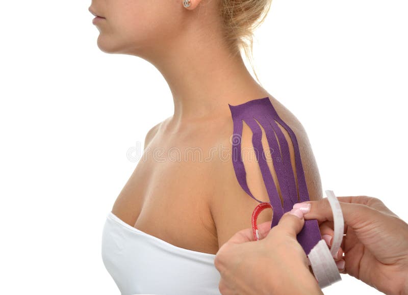 Lekarka wręcza stosować specjalnej physio taśmy na kobiety ramieniu obraz royalty free Lekarka wręcza stosować specjalnej physio taśmy na kobiety ramieniu obraz royalty free