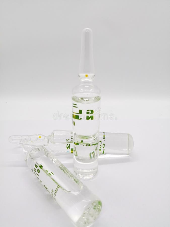 Medication and healthcare concept. Many transparent ampule of glucose solution, used to treat low blood sugar hypoglycemia, insulin shock, or dehydration fluid loss. on white background and copy space. Medication and healthcare concept. Many transparent ampule of glucose solution, used to treat low blood sugar hypoglycemia, insulin shock, or dehydration fluid loss. on white background and copy space.
