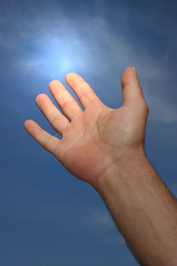 Hand of a man reaching to towards a blue sky with a light glow coming from his forefinger. Hand of a man reaching to towards a blue sky with a light glow coming from his forefinger.