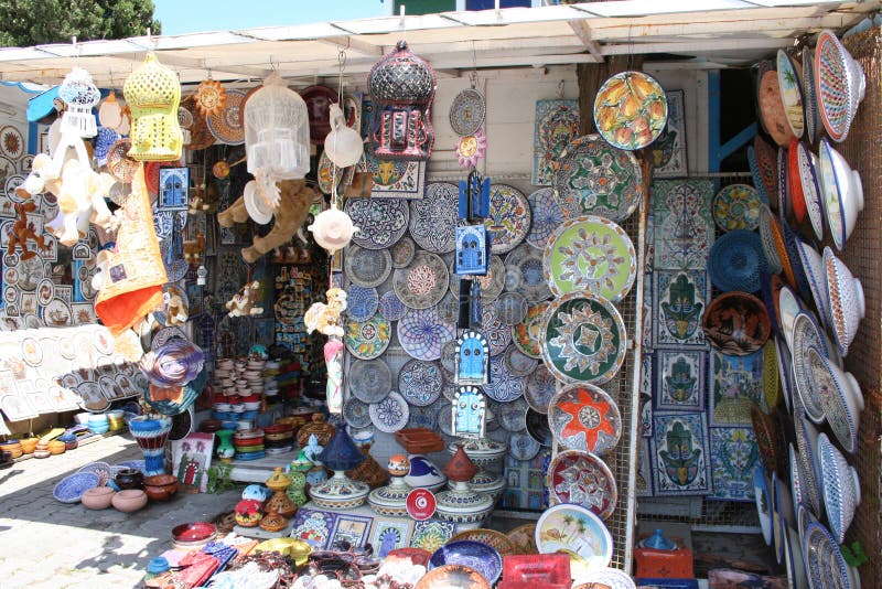 Tunisian souvenirs on display at a street market in Sidi Bou Said, Tunisia: Plates and bowls in white, blue, orange and yellow. Tunisian souvenirs on display at a street market in Sidi Bou Said, Tunisia: Plates and bowls in white, blue, orange and yellow