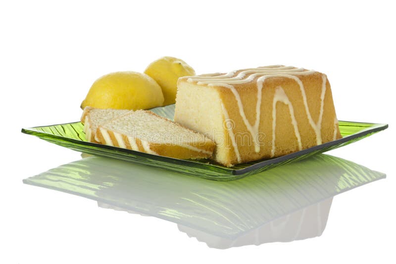 Lemon cake on glass plate, lemons in background