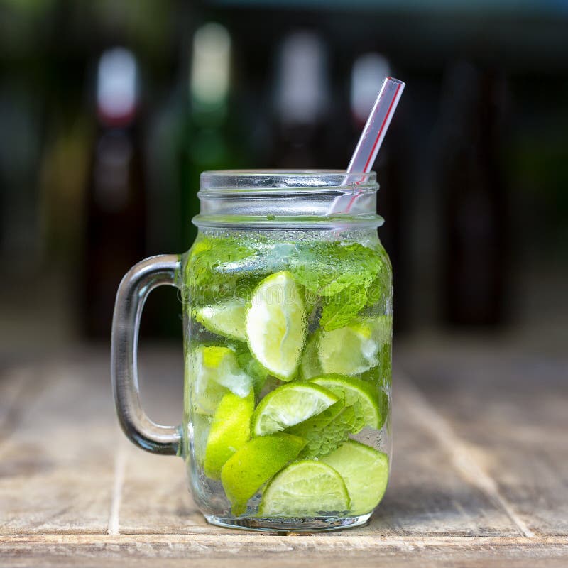 Lemon fruit Caipirinha alcoholic beverage of Brazil on wooden table. Lemon fruit Caipirinha alcoholic beverage of Brazil in glass mug on wooden table, close up stock photos Lemon fruit Caipirinha alcoholic beverage of Brazil on wooden table. Lemon fruit Caipirinha alcoholic beverage of Brazil in glass mug on wooden table, close up stock photos