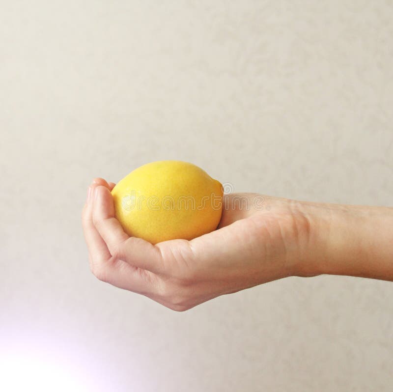 Lemon. The fruit of Yellow Lemon Lies on the Hand royalty free stock photo Lemon. The fruit of Yellow Lemon Lies on the Hand royalty free stock photo