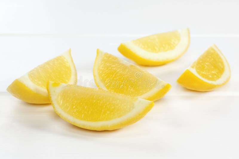 Lemon Wedges on White Background stock photo