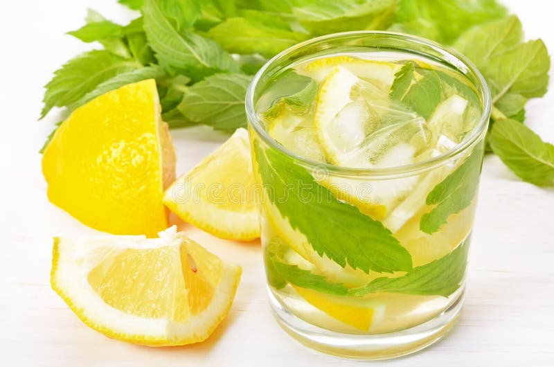 Lemonade with fresh lemon and mint in glass. Lemonade with fresh lemon and mint in glass