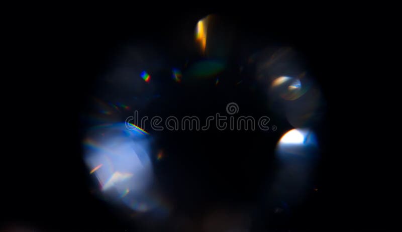 Lens Flare, Abstract Bokeh Lights. Leaking Reflection of a Glass, Crystal, Defocused Shining Colorful rainbow Light Leaks, Rays on Black Background